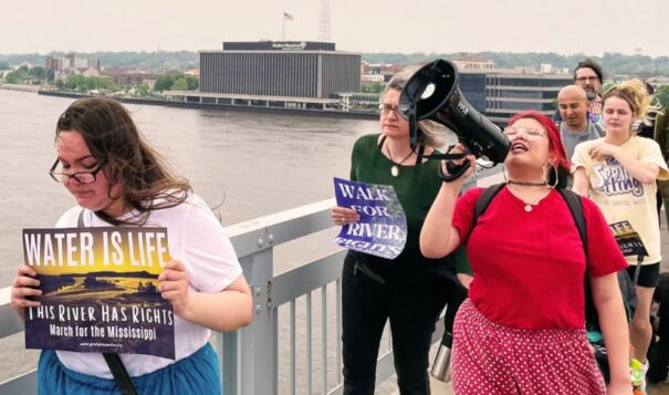 Advocates march over the Centennial Bridge, which connects Illinois and Iowa in the Quad Cities, on May 13, 2023. They called for the Mississippi River to be granted legal rights. (Juanpablo Ramirez-Franco, WNIJ)