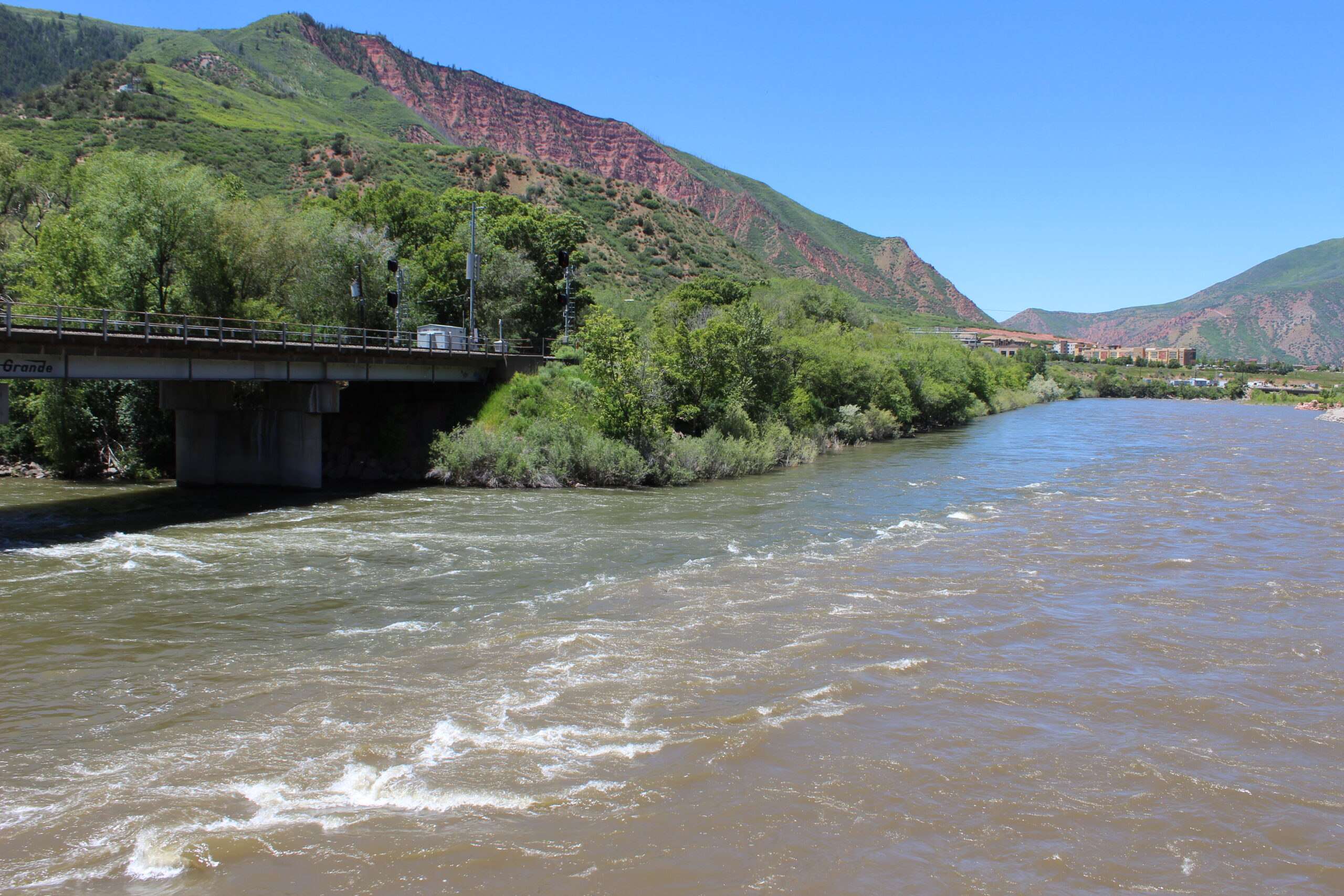 The confluence of the Roaring Fork and Colorado rivers in Glenwood Springs shows the differences between the two rivers in color and chemistry. But both have faced lower flows and warmer temperatures in recent years, impacted by human caused climate change.