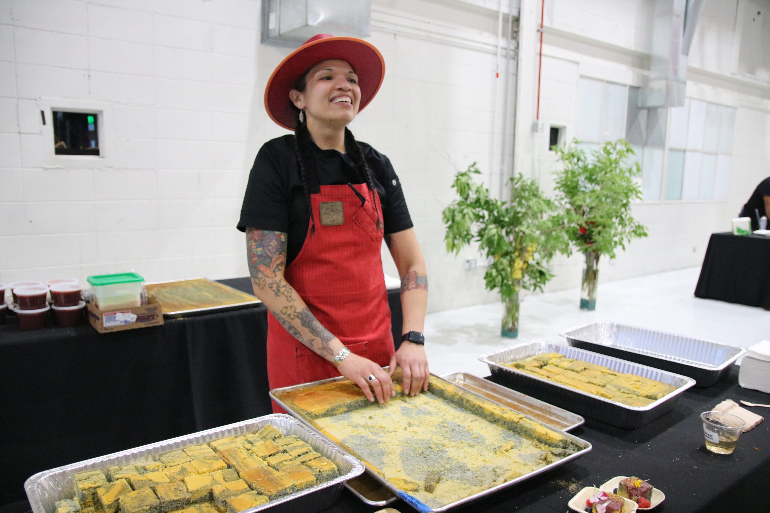 Emma VandenEinde
/
KUNC
Andean Chef Andrea Murdoch stands in front of her Ute Mountain Ute Blue Cornmeal Swirl cake at the Denver EATSS event at Stanley Marketplace in Aurora, Colo., on June 14, 2023. She's one of the five Indigenous chefs that were picked to share a meal with guests.