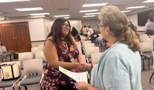 Adrianna Adame, Report for America corps member visits wtih Lucy Fredericks, director of Indian/multicultural education, during the North Dakota Indian Education Summit at the North Dakota State Capitol on Friday, July 7. (Photo/Jodi Rave Spotted Bear)