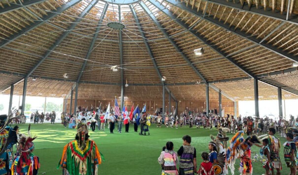 North American Indian Days attendees stand for the color guard during grand entry on Friday, July 7, 2023 in Browning, MT. (JoVonne Wagner, ICT)