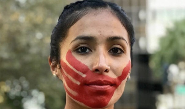Jordan Daniel, a runner and a member of the Lowere Brule Sioux Tribe in South Dakota, wears a red handprint across her face when she runs, to bring attention to missing and murdered Indigenous women, in this 2020 file photo. (Photo courtesy Devin Whetstone)