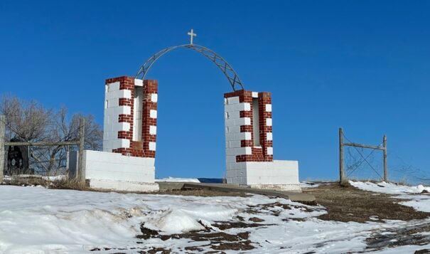 The Wounded Knee Memorial, shown here in February 2023, marks the site of the massacre of hundreds of Lakota people by U.S. soldiers in 1890. A ceremony marking the 50 years since the occupation of Wounded Knee by American Indian Movement activists will be held at the site on Feb. 27, 2023, after four days of events leading up to the anniversary. (Photo by Kalle Benallie/ICT)