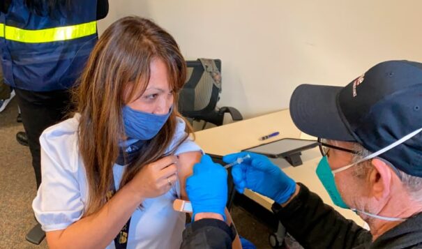 In this Feb. 19, 2021, file photo, Grace John, who works at a school in San Lorenzo, gets a COVID-19 shot at a mobile vaccination clinic run by the Federal Emergency Management Agency and the state in Hayward, California. (AP Photo/Terry Chea, File)