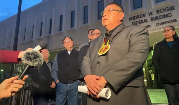 Oglala Sioux Tribe President Frank Star Comes speaks to reporters Feb. 2023 after the first day of hearings in Oglala Sioux Tribe v. United States. The tribe alleges that the United States has failed their treaty obligations by providing inadequate law enforcement funding. (Photo by Shalom Baer Gee, Rapid City Journal)