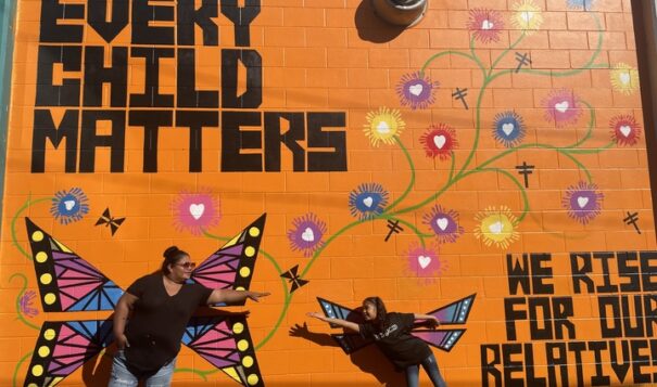 Melanie Moniz and her 9-year-old daughter Angelina Grace helped paint dragonflies and butterflies on the mural, representing messengers and protectors on Sept. 30. Photo credit/Adrianna Adame