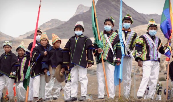 Schoolchildren of the Kallawaya Nation of northern Bolivia marched in their traditional dress and performed their music with traditional instruments in the procession that begins the snow festival in Ayllu Amarete. The festival is a reinforcement and a reminder of the importance of their ancestral memory. (Image from Cosmology & Pandemic: Legacy of the Andes / The Esperanza Project)