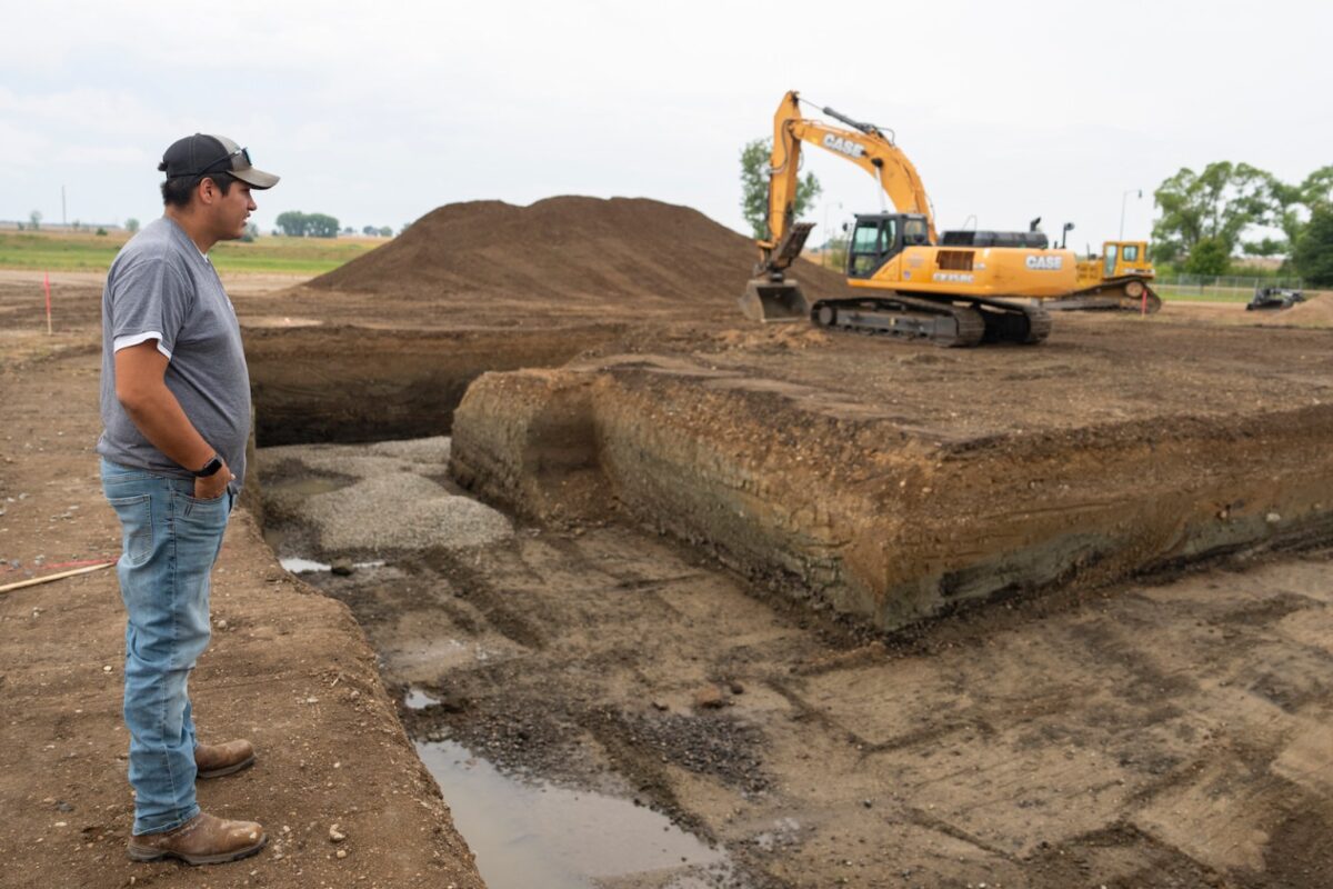 Joey Goodthunder, whose primary job is growing the Lower Sioux Indian Community’s hemp, looks over the beginnings of a foundation for a building to house the tribe’s processing equipment. (Aaron Nesheim/Grist)