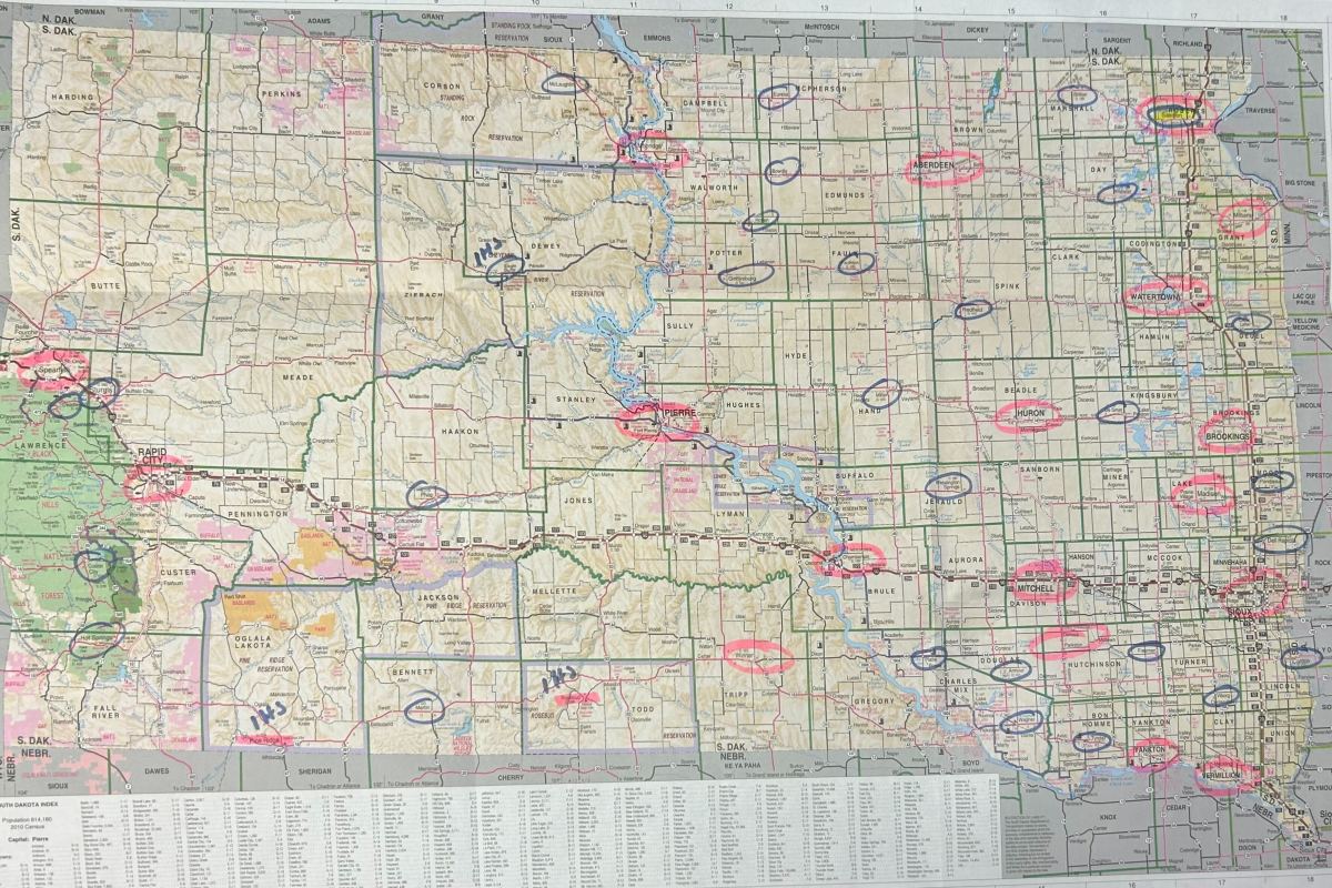 A map of healthcare facilities in South Dakota from the Coteau Des Prairies Health Care Center. Hospitals circled in pink provide specialized OB-GYN care, hospitals circled in blue lack specialized services. (Photo by Amelia Schafer ICT/Rapid City Journal)