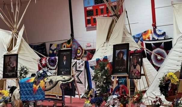 On Tuesday, April 16, the casket of Cole Brings Plenty rests before three tipis representing his family tiospayes. All photos reprinted with permission of Brings Plenty family. Photo Credit/Jodi Rave Spotted Bear