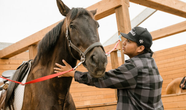 Rocky makes a special connection with Oso at Forward Stride ranch near Beaverton, Oregon. The ranch provides Indigenous youth with equine therapy. Photo by Josué Rivas.